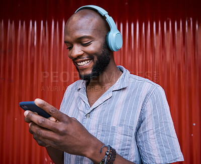 Buy stock photo Black man, smartphone and headphones, smile with technology and listening to music or podcast. Communication, social media and online chat, audio streaming and subscription with network and gen z