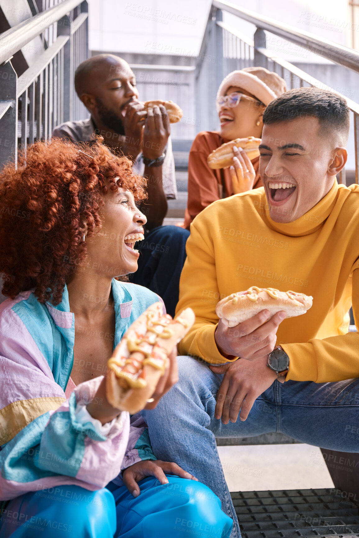 Buy stock photo People, city and friends eating hotdog outdoor for travel, funny laugh and fun on stairs. Diversity, happiness and gen z group of men and women with food on date, adventure and freedom in urban town