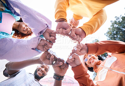 Buy stock photo Friends, hands and people fist bump outdoor for trust, community and fun circle. Diversity, happiness and below gen z group of men and women with solidarity for teamwork, youth and freedom in nature