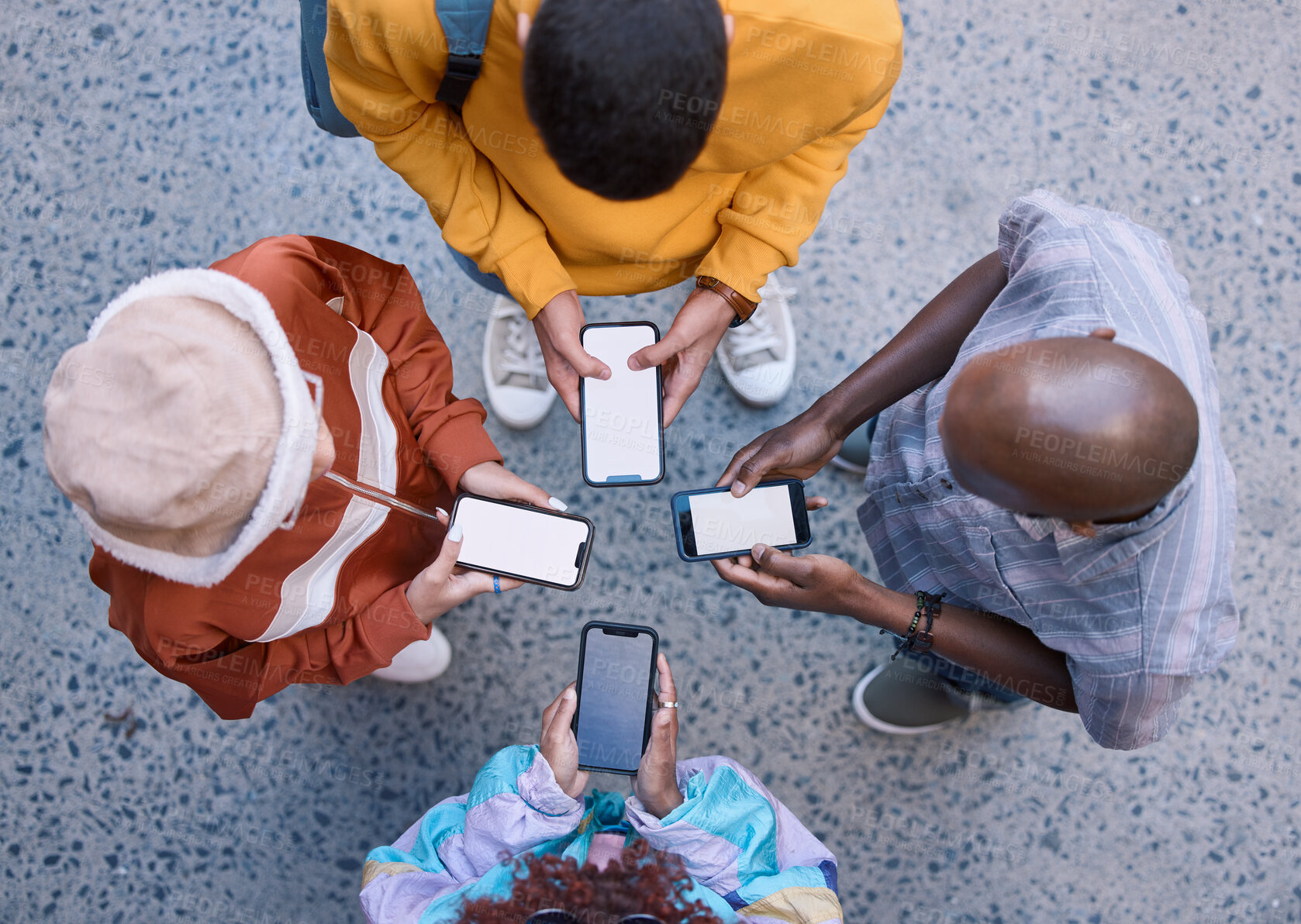 Buy stock photo Friends, circle and phone in top view, outdoor and texting on social media, app and web communication. Group, gen z students or people with smartphone, internet and contact in urban street in city