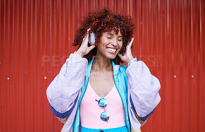Buy stock photo Music, dance and headphones with a retro woman on a red background in the city for energy or freedom. Radio, smile and streaming audio with a happy young afro person listening to sound for wellness