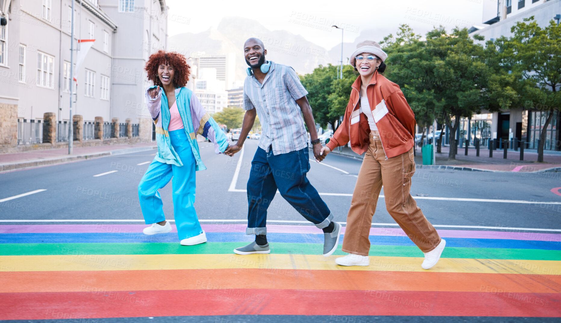 Buy stock photo Lgbtq, people holding hands and rainbow on street, paint and community with gen z, happiness and fashion in city. Urban streetwear, pride and queer support with ally, different or unique in portrait