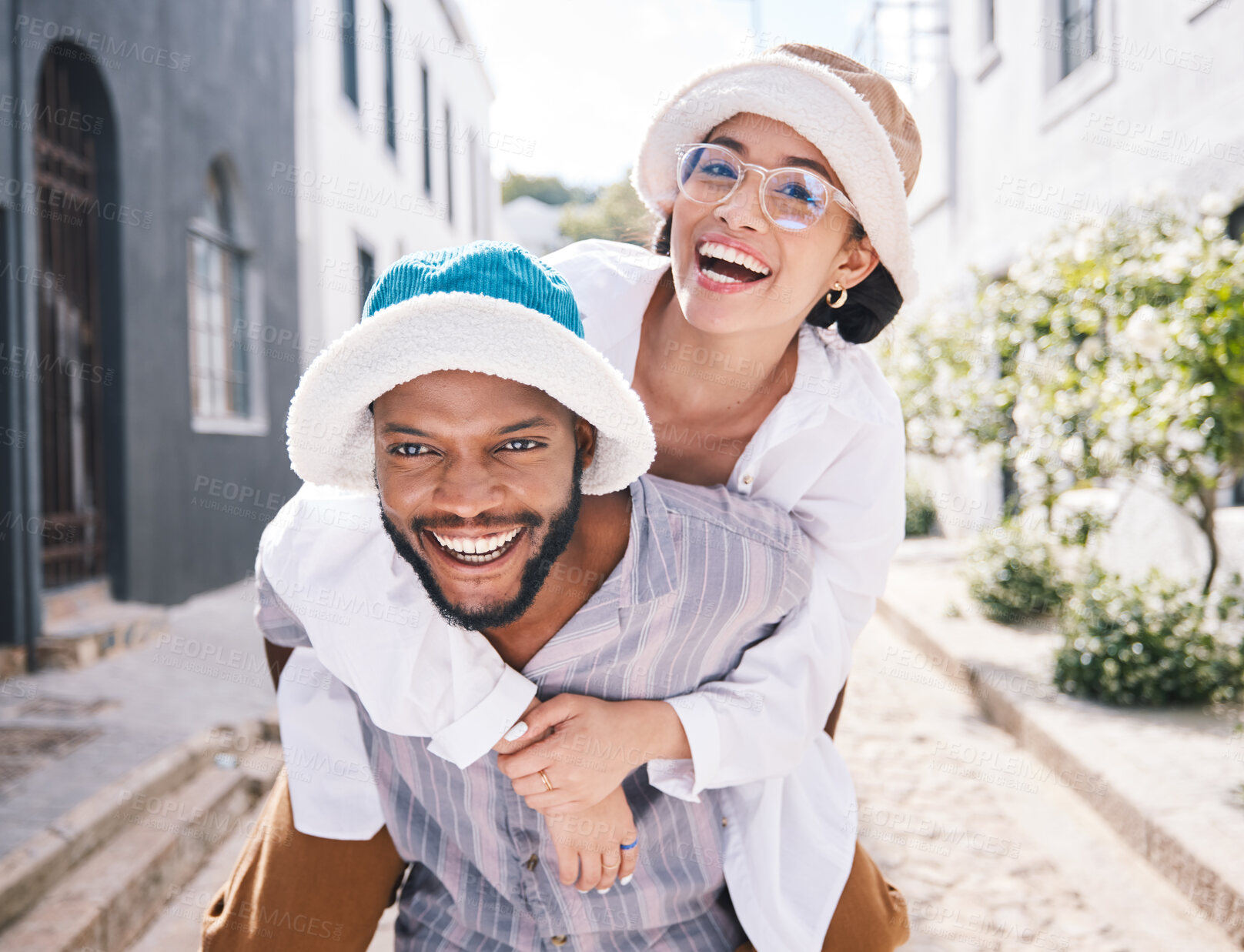 Buy stock photo Happy couple, love or piggyback portrait in city to travel on romantic date to play a funny outdoor game. Smile, interracial or happy man carrying gen z woman in silly, goofy or playful joke together