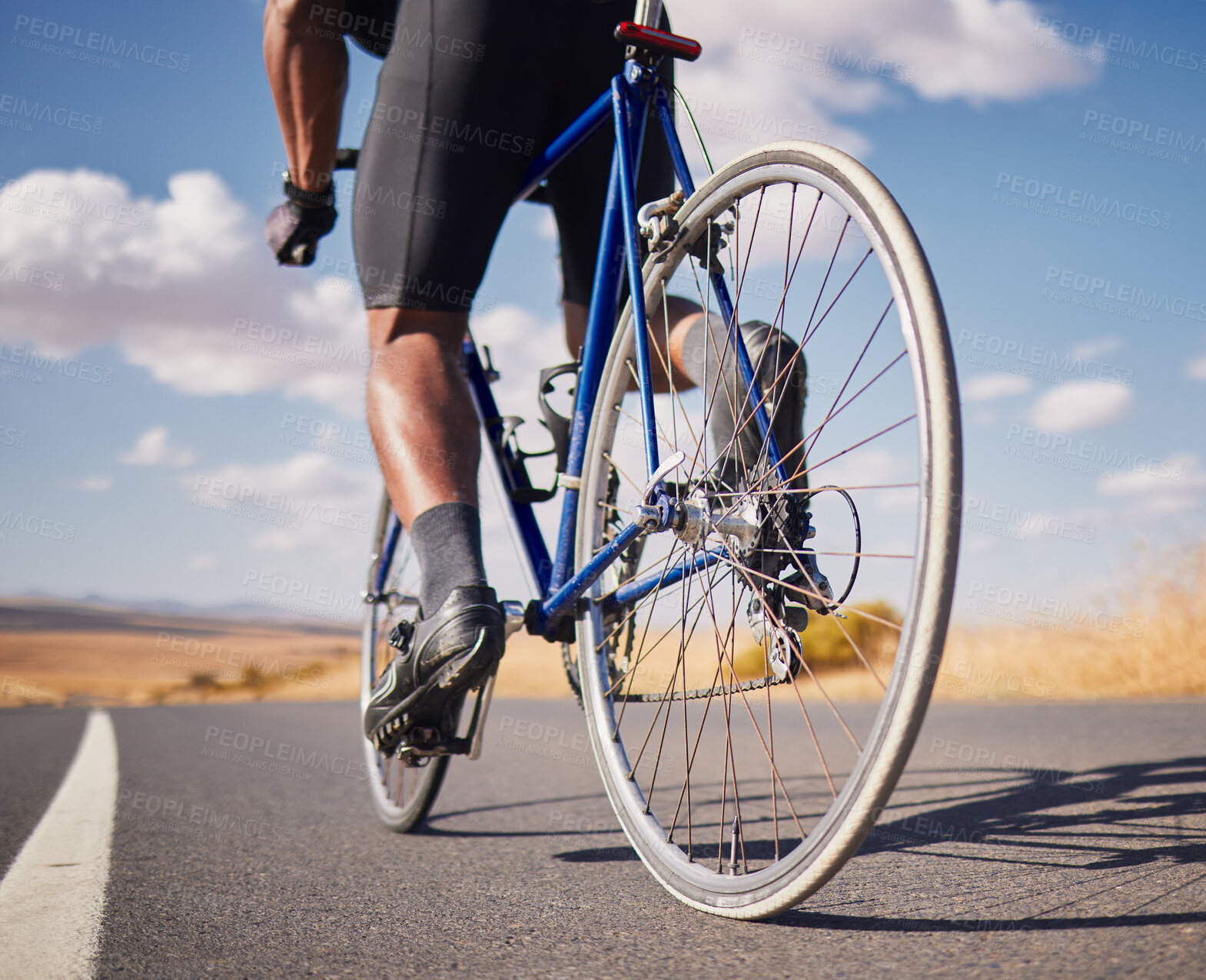 Buy stock photo Road, closeup and man on a bike for cycling, race training or travel in the countryside. Health, exercise and legs of male cyclist or athlete with a bicycle for a workout, street cardio or triathlon