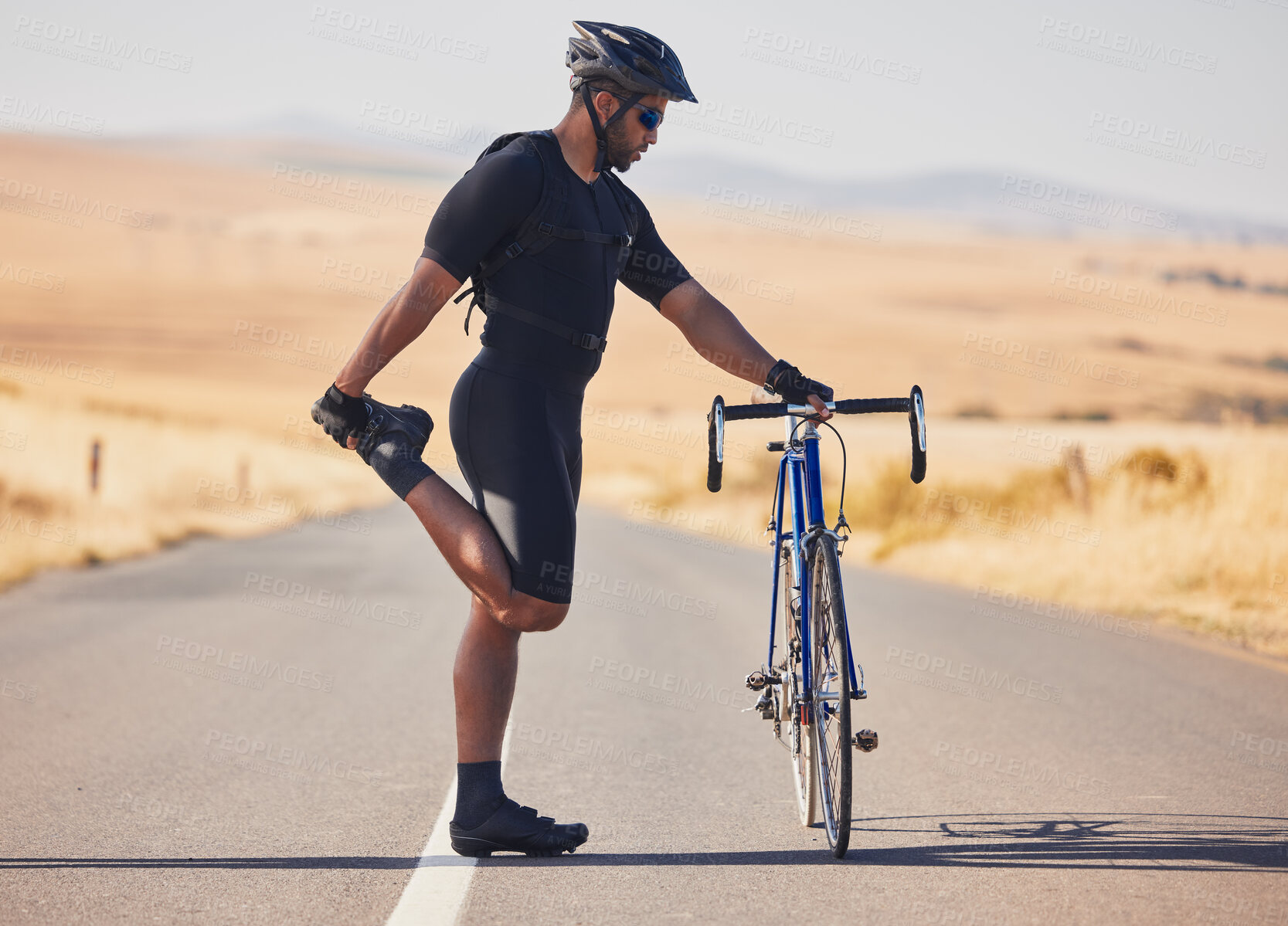 Buy stock photo Man, cyclist and stretching on road with bicycle in fitness, training or outdoor sports in countryside. Active male person or athlete in body warm up, leg exercise or preparation in cycling or cardio