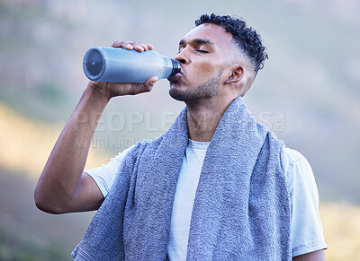 Buy stock photo Fitness, exercise and a man drinking water outdoor on a break or rest after run, workout or training. Tired athlete person or runner in nature with a bottle for thirst, cardio or health and wellness