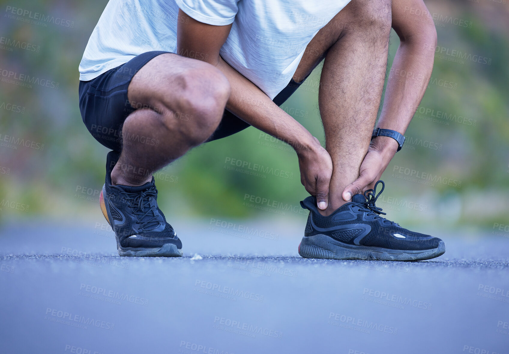 Buy stock photo Fitness, exercise and a man with ankle injury outdoor on run, workout or training. Closeup of athlete person or runner with running shoes and leg pain, hurt muscle or accident on a road for cardio 