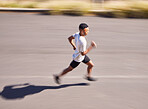 Health, running and motion blur with a sports man on a road for his cardio or endurance workout. Exercise, fitness and a runner training for a marathon or challenge in the mountains during summer