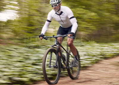 Buy stock photo Fast, fitness and man on a bike in nature for a race, sports or fitness. Energy, mountains and a male cyclist on a bicycle in the woods with speed for exercise, cardio or training in a forest