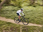 Cycling, fitness and man with mountain bike in forest for speed, training or nature workout with top view off road race. Extreme sports, bicycle or cyclist in woods for workout, performance or ride
