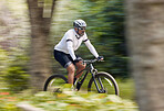 Freedom, fitness and man cycling in forest with energy, training or nature, workout and off road race. Speed, workout and cyclist on mountain bike for extreme sports, adrenaline or power performance