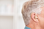 Hearing aid, closeup and ear of man with disability for medical support, help listening or healthcare at mockup space. Face of deaf patient with audiology implant for sound waves, amplifier or volume