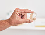 Hearing aid, hands and person with disability for medical support, healthcare innovation and volume. Closeup of deaf patient with audiology implant to help sound waves, amplifier or improve listening