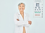 Portrait, ophthalmologist and woman arms crossed in hospital mockup space for healthcare of vision. Face, confident optometrist and happy doctor, mature expert optician and physician smile in India