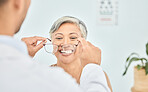 Smile, glasses and hands of ophthalmologist on woman in hospital for vision, healthcare or wellness. Frame, optometrist and mature patient happy for eyewear, lens or prescription spectacles in clinic