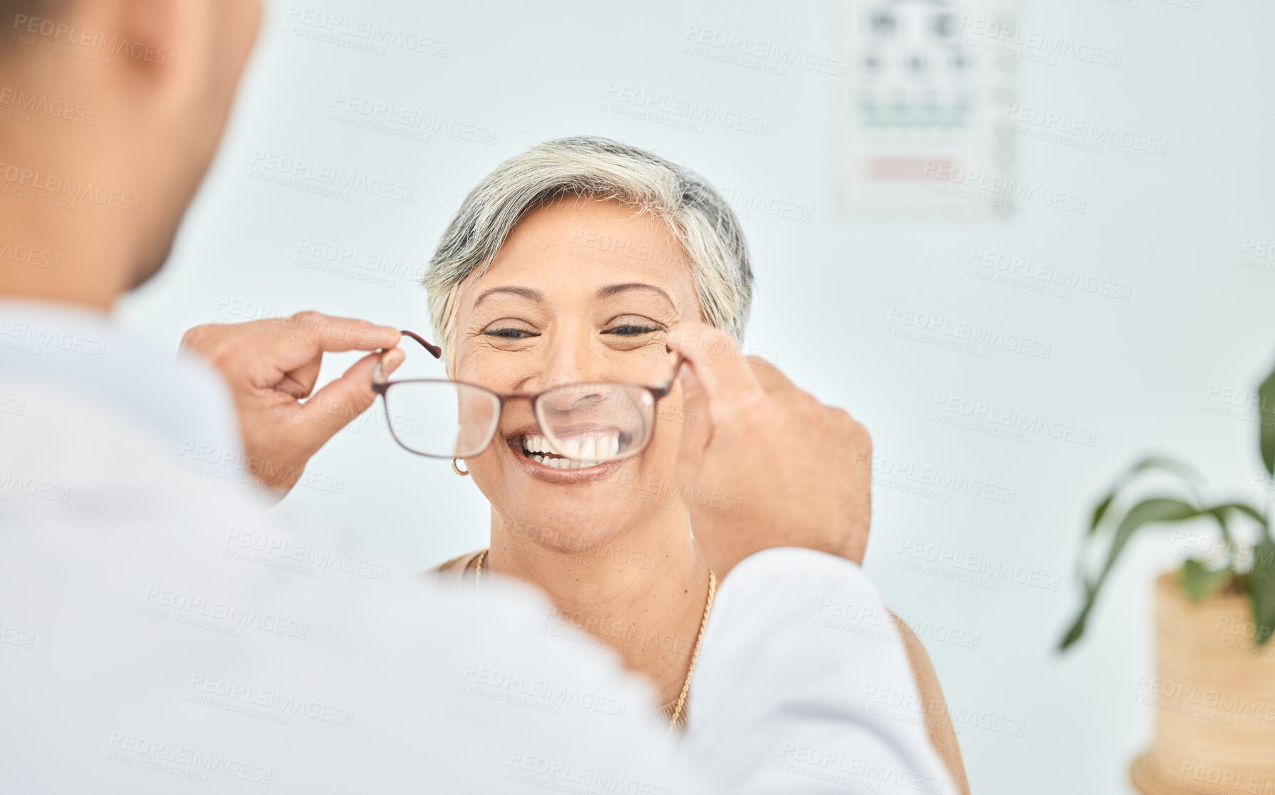 Buy stock photo Smile, glasses and hands of ophthalmologist on woman in hospital for vision, healthcare or wellness. Frame, optometrist and mature patient happy for eyewear, lens or prescription spectacles in clinic