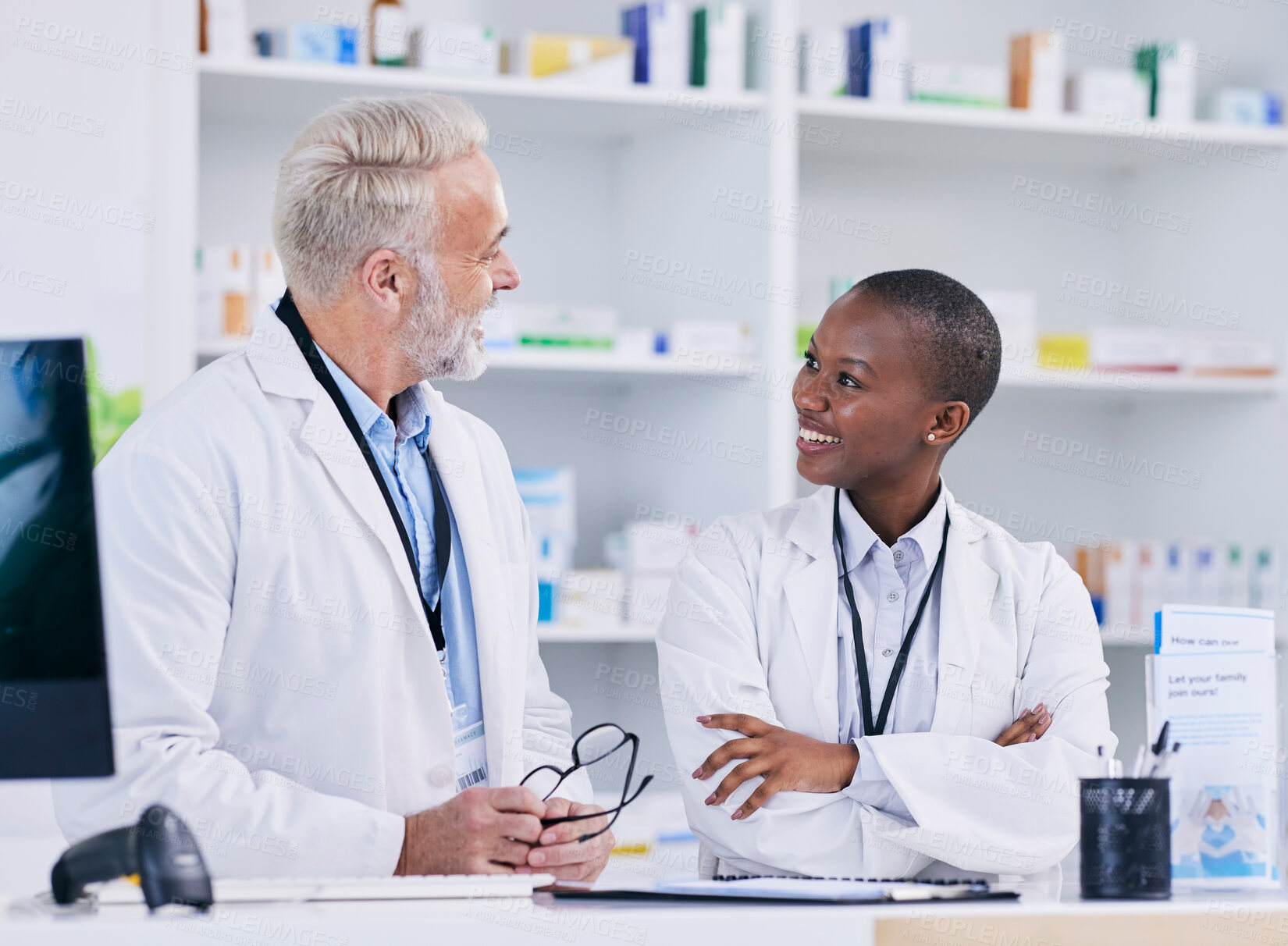 Buy stock photo Discussion, team and pharmacists with medication in pharmacy for healthcare or medical career. Conversation, medicine and senior chemist mentor talking to female pharmaceutical student by dispensary.