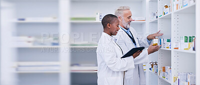 Buy stock photo Discussion, tablet and pharmacists checking medication for inventory, stock or medical research. Healthcare, medicine and senior chemist mentor teaching female pharmaceutical student with technology.