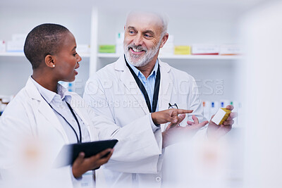 Buy stock photo Conversation, tablet and pharmacists checking medication for inventory, stock or medical research. Healthcare, medicine and senior chemist mentor teaching female pharmaceutical student with tech.