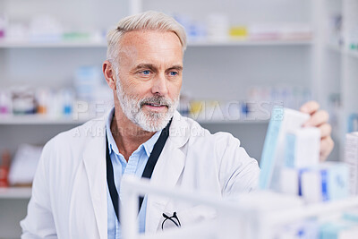 Pharmacist, man and medicine box for shelf management, reading label and stock research or medical inventory. Senior doctor with healthcare or clinic product for pharmacy, store pills or drugs check