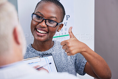 Buy stock photo Vision, eye exam and woman with thumbs up for glasses, prescription and test for eyewear and thank you to optometrist. Happy, African customer and doctor for health, consultation or eyesight care