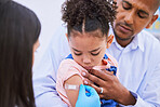 Pediatrician, dad and girl with plaster for vaccine, flu shot or medicine injection in clinic or hospital. Father, kid with bandage and doctor in office for vaccination, consultation and child care.