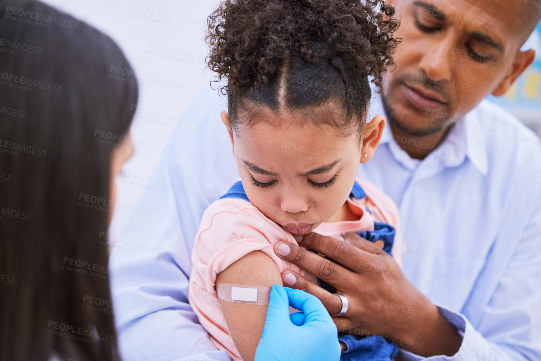 Buy stock photo Pediatrician, dad and girl with plaster for vaccine, flu shot or medicine injection in clinic or hospital. Father, kid with bandage and doctor in office for vaccination, consultation and child care.