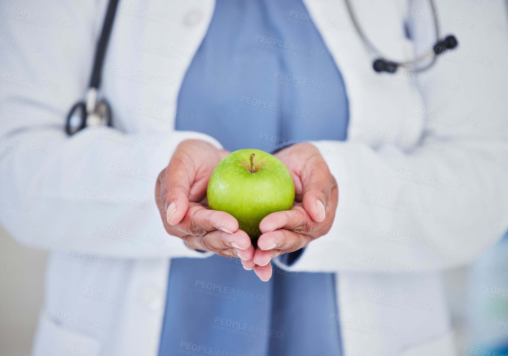 Buy stock photo Doctor, hands and apple in healthcare diet, natural nutrition or healthy vitamin food at the hospital. Closeup of medical professional holding organic green fruit for health and wellness at clinic