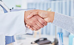 Healthcare, handshake and woman consulting doctor in a hospital with trust, help and suppport. Health, consultation and patient shaking hands with medic for thank you, gratitude and surgery success 