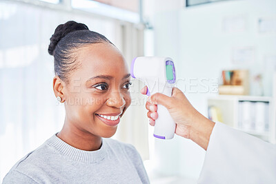 Buy stock photo Black woman, doctor and infrared thermometer for temperature, fever or checkup at the hospital. Happy African female person or patient smile in screening, visit or regulation for health and safety