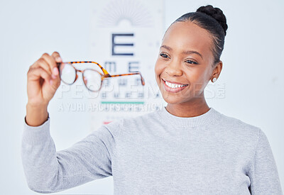 Buy stock photo Eye care, glasses choice and patient, black woman is happy at clinic, optometry and frame with help and healthcare. Wellness, health and prescription lens, eyewear and decision with vision and smile