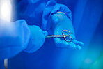 Closeup, surgery and hands with a scissor for healthcare, hospital work and help. Support, team and doctors, surgeons or medical employees with gear for cardiology or professional cooperation