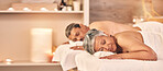 Relax, massage and couple in spa for holiday, vacation and anniversary weekend with candles. Love, luxury resort and mature man and woman sleeping in salon for beauty, therapy and skincare treatment