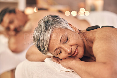 Buy stock photo Hot stone, massage and zen with old couple in spa for vacation, luxury and beauty salon. Peace, wellness and holiday with senior woman and man in hotel villa for retirement, treatment and body care