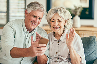 Buy stock photo Video call, hello and smile with old couple and phone on sofa for streaming, social media and communication. Network, internet and wave with senior man and woman in living room at home for mobile app