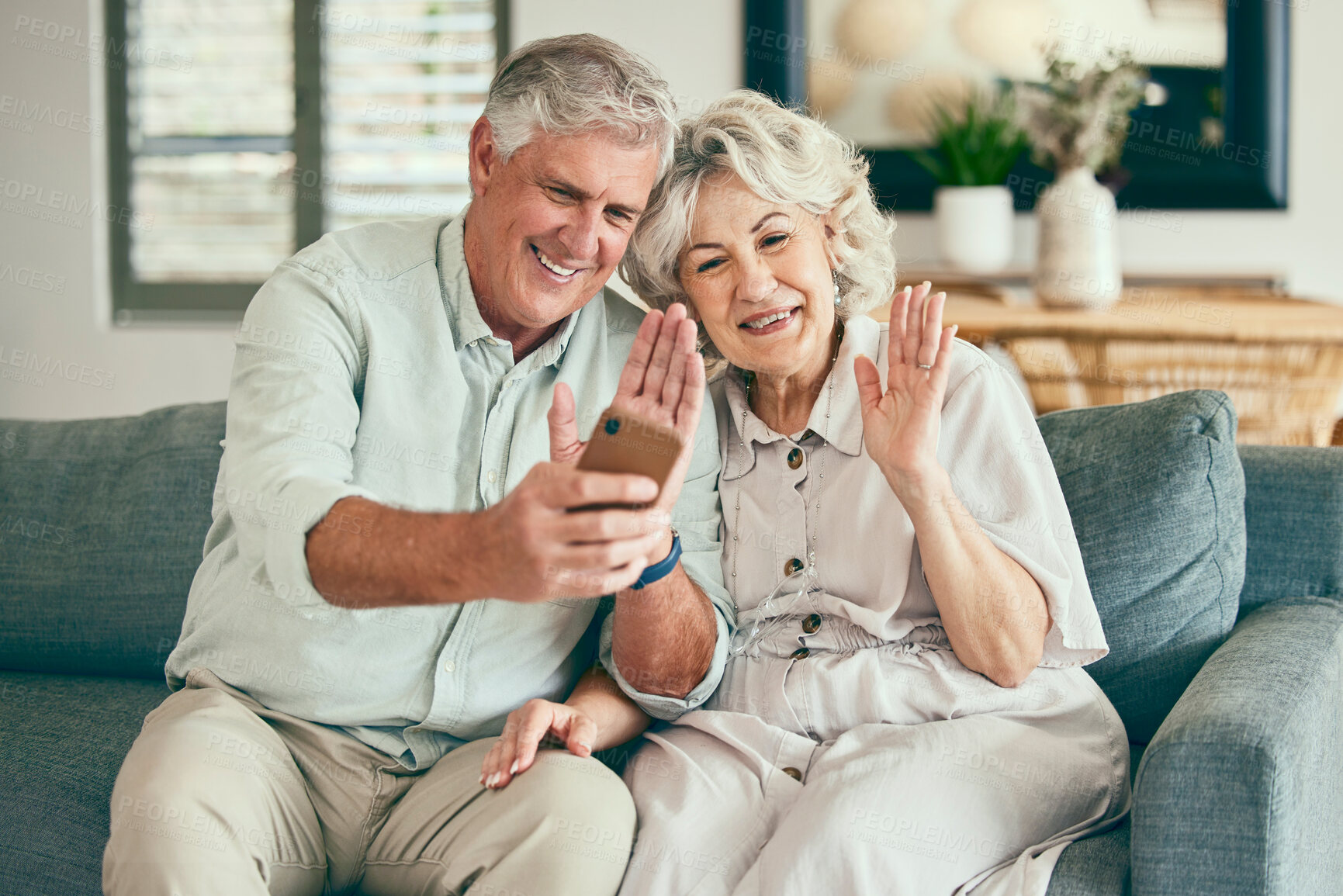 Buy stock photo Wave, phone and video call with old couple on sofa for streaming, social media or communication. Network, internet and happy with senior man and woman in living room at home for hello and mobile app