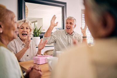 Buy stock photo Senior friends, birthday celebration and party at a home with a present and gift with excited people. Surprise, singing and retirement of elderly group at a dining room table together with a smile