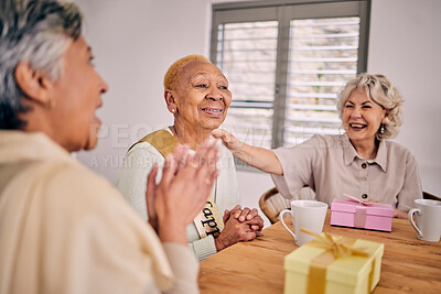 Buy stock photo Senior friends, birthday singing and party at a home with a present and gift with excited people. Surprise, celebration and retirement of elderly group at a dining room table together with a smile