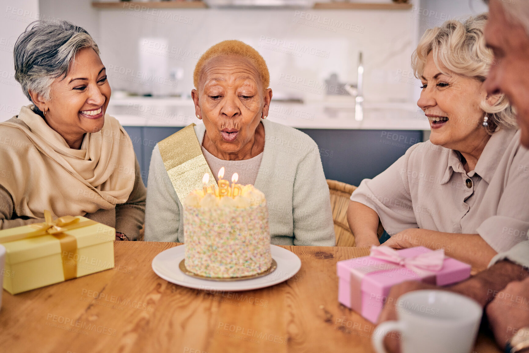 Buy stock photo Senior women, friends and candles on birthday cake for a celebration, party and social gathering. Elderly people together at table to celebrate and blow flame at retirement home event with happiness