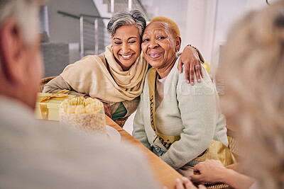 Buy stock photo Happy, smile and senior friends hugging at a birthday party, celebration or event at retirement home. Excited, bonding and elderly women embracing with love, care and happiness in a modern house.