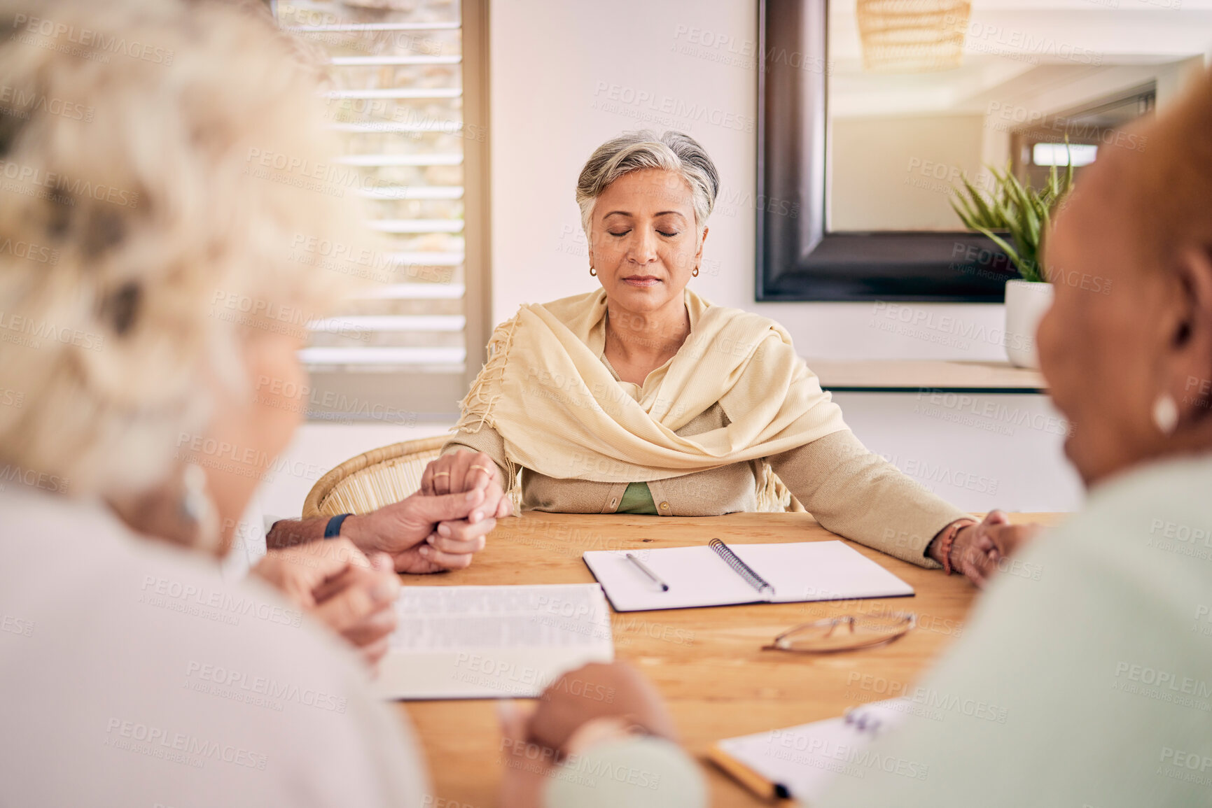 Buy stock photo Senior people, group prayer and holding hands at table together, support and worship Holy Spirit, Jesus Christ and God. Elderly friends, religion and gratitude in home, hope and spiritual faith.