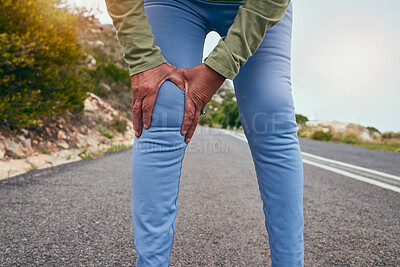 Knee pain, road and fitness of a senior person with massage and sport injury from exercise. Street, running and path of a athlete with joint inflammation, muscle issue and hands on leg outdoor