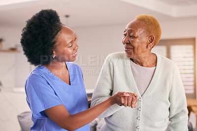 Buy stock photo Help, nurse and holding hands of senior black woman, care and smile in house together. Caregiver, support and elderly patient with medical professional, kindness and happy in empathy for healthcare