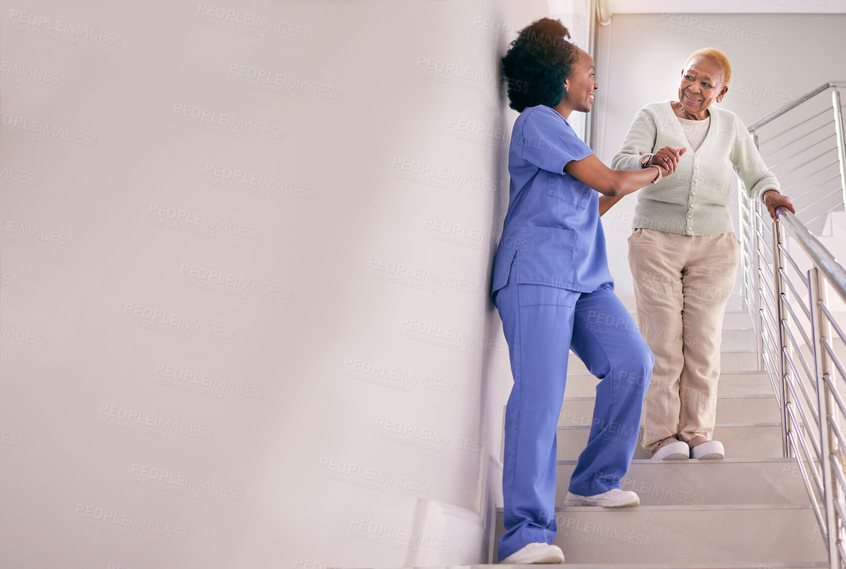 Buy stock photo Nurse, stairs and help senior woman, holding hands and assistance in home. Caregiver, steps and elderly African patient walking down, support of person with a disability and happiness in healthcare