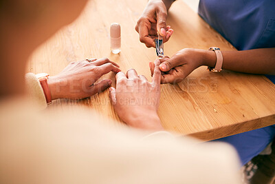 Buy stock photo Cosmetics, grooming and hands for home manicure, beauty treatment or service at a table. Spa, wellness and closeup of person with a client for the process of cutting nails for luxury care on fingers