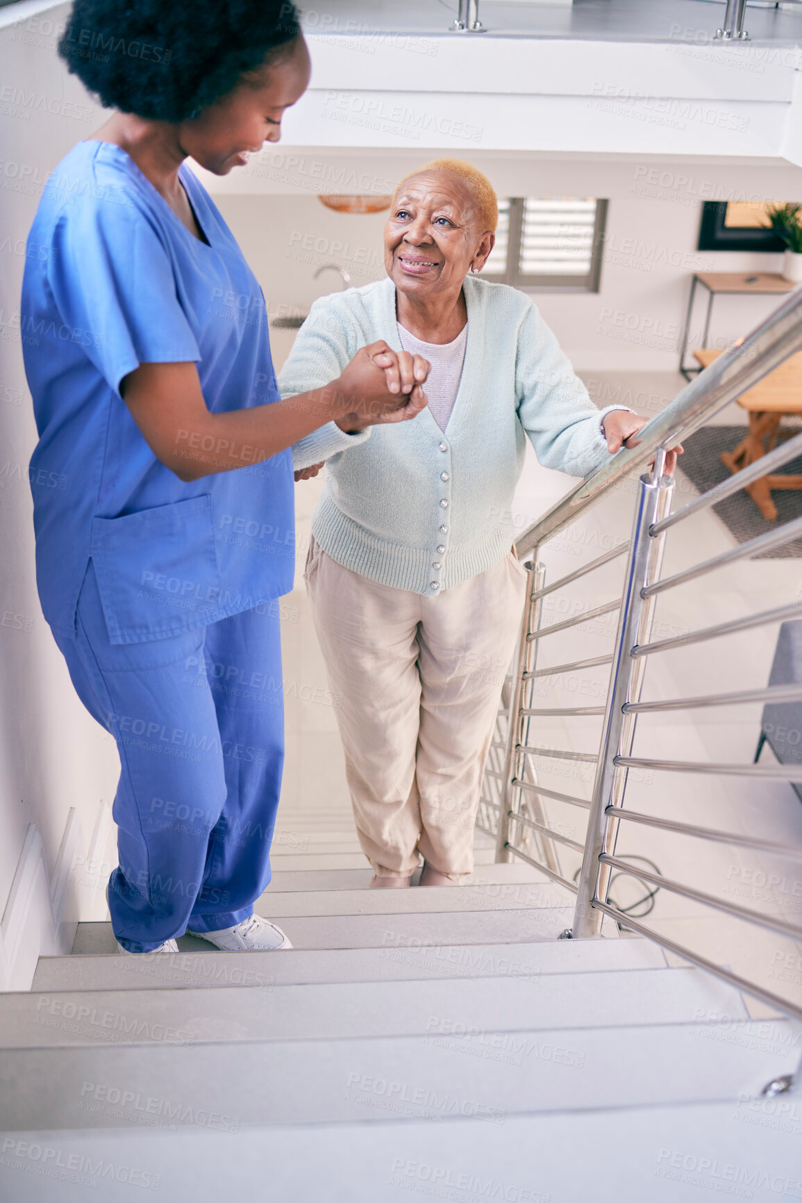 Buy stock photo Caregiver, stairs and elderly woman holding hands, help and assistance in home. Nurse, steps and senior African patient walking up, support of person with a disability and happiness in healthcare