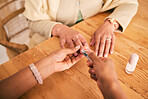 Above, grooming and hands for a home manicure, beauty treatment or service at a table. Spa, wellness and closeup of a person with a client for the process of cutting nails for luxury care on fingers