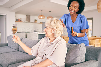 Buy stock photo Caregiver brush hair of senior woman in the living room of the modern retirement home for self care. Mirror, routine and African female nurse doing a hairstyle for an elderly patient in the lounge.