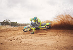 Desert, dirt and motorbike cycling for sports, agile driving and off road adventure with speed, power and mockup space on cloudy sky. Motorcycle, rally challenge and driver in fast race on sand dunes