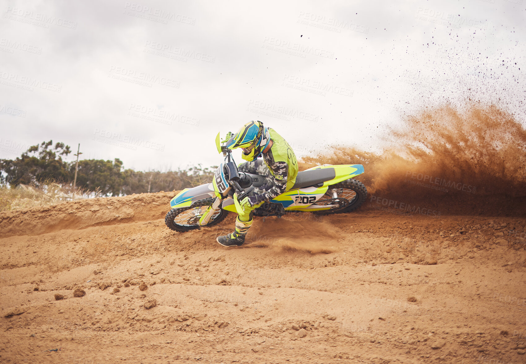 Buy stock photo Desert, dirt and motorbike cycling for sports, agile driving and off road adventure with speed, power and mockup space on cloudy sky. Motorcycle, rally challenge and driver in fast race on sand dunes